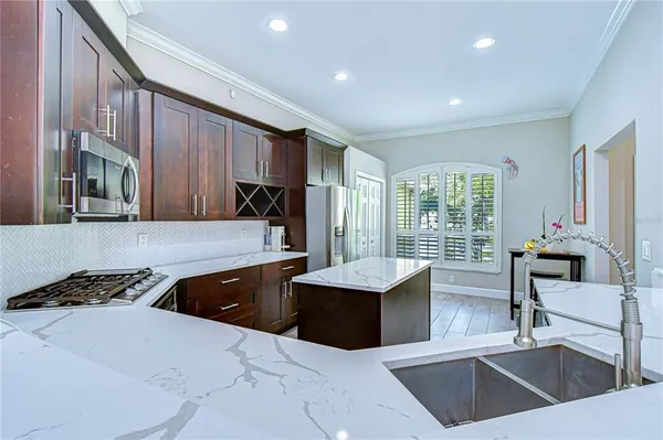 a kitchen with stainless steel appliances a sink stove and cabinets