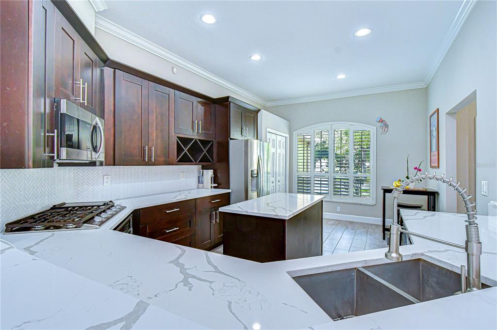 14112 Creek Run Drive Riverview, FL 33579 - Photo 11 of 40 a kitchen with stainless steel appliances a sink stove and cabinets