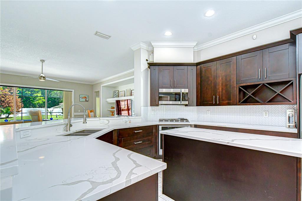 14112 Creek Run Drive Riverview, FL 33579 - Photo 13 of 40 a kitchen with a sink a counter top space and appliances