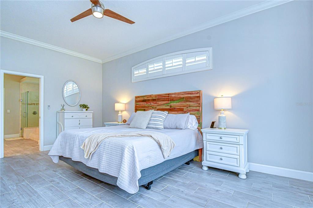 14112 Creek Run Drive Riverview, FL 33579 - Photo 20 of 40 a bedroom with a bed and a chandelier