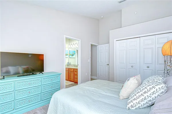a bedroom with a bed and a flat screen tv