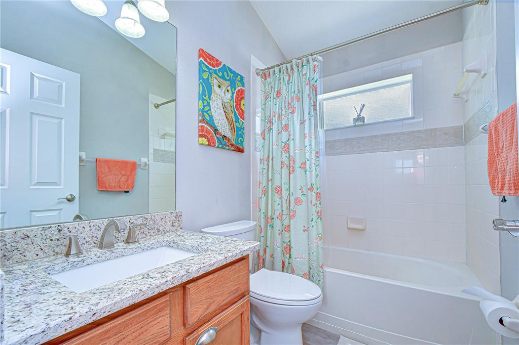 14112 Creek Run Drive Riverview, FL 33579 - Photo 26 of 40 a bathroom with a granite countertop sink and a mirror