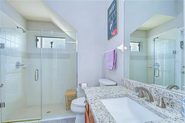 a bathroom with a granite countertop tub sink and shower