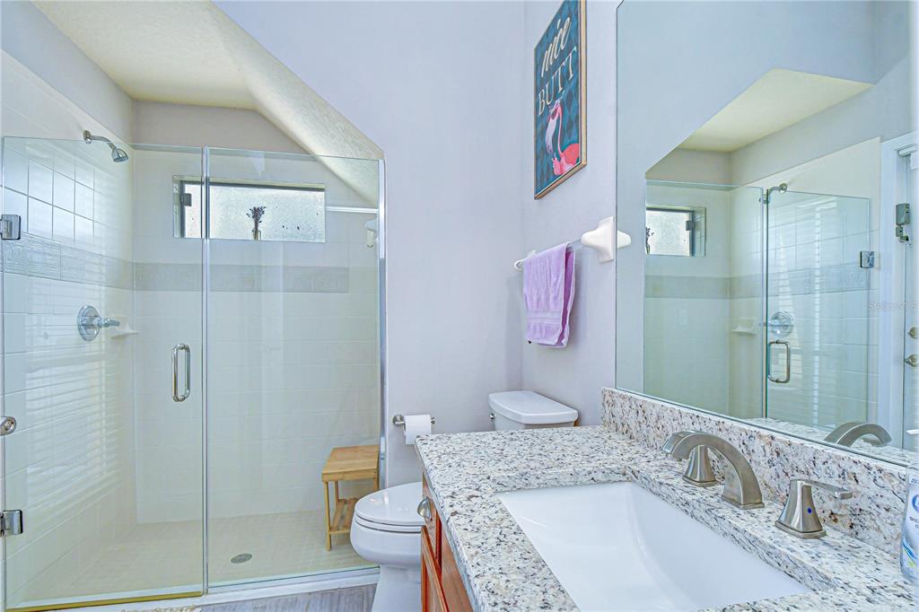 14112 Creek Run Drive Riverview, FL 33579 - Photo 29 of 40 a bathroom with a granite countertop tub sink and shower