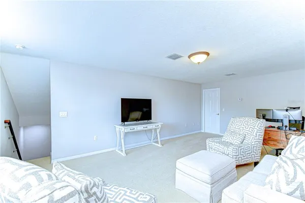 a bedroom with furniture and a flat screen tv