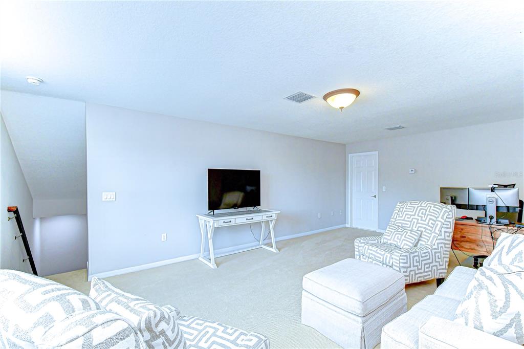 14112 Creek Run Drive Riverview, FL 33579 - Photo 30 of 40 a bedroom with furniture and a flat screen tv