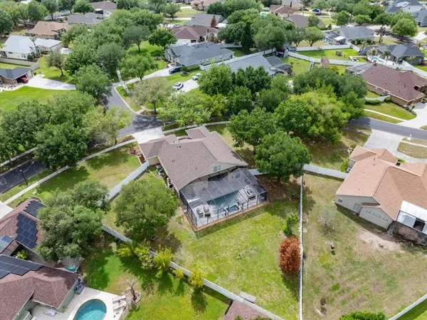 an aerial view of a house with a garden and lake view