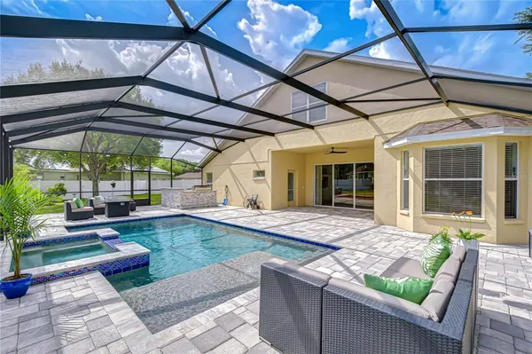 a swimming pool with patio outdoor seating and yard