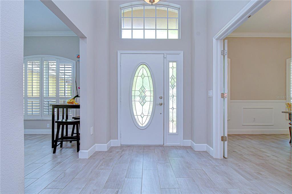 14112 Creek Run Drive Riverview, FL 33579 - Photo 7 of 40 an empty room with wooden floor mirror and window