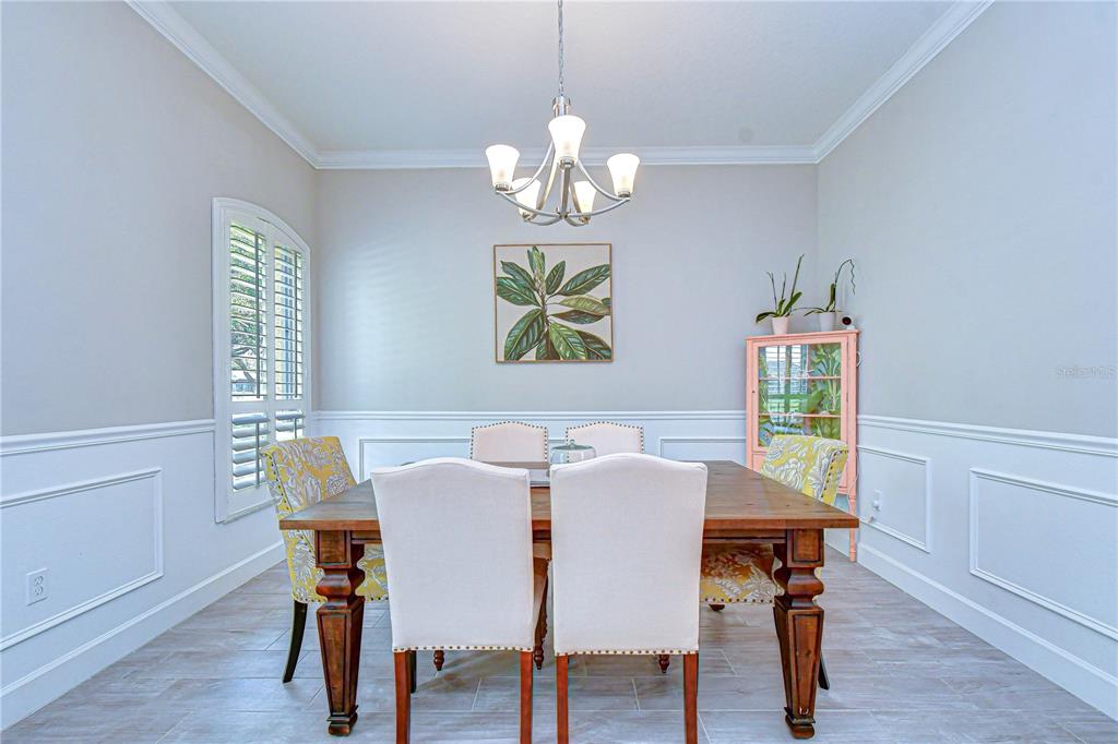 14112 Creek Run Drive Riverview, FL 33579 - Photo 8 of 40 a view of a dining room with furniture a chandelier and wooden floor