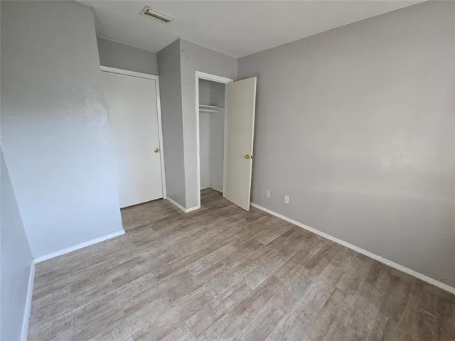 a view of an empty room and wooden floor