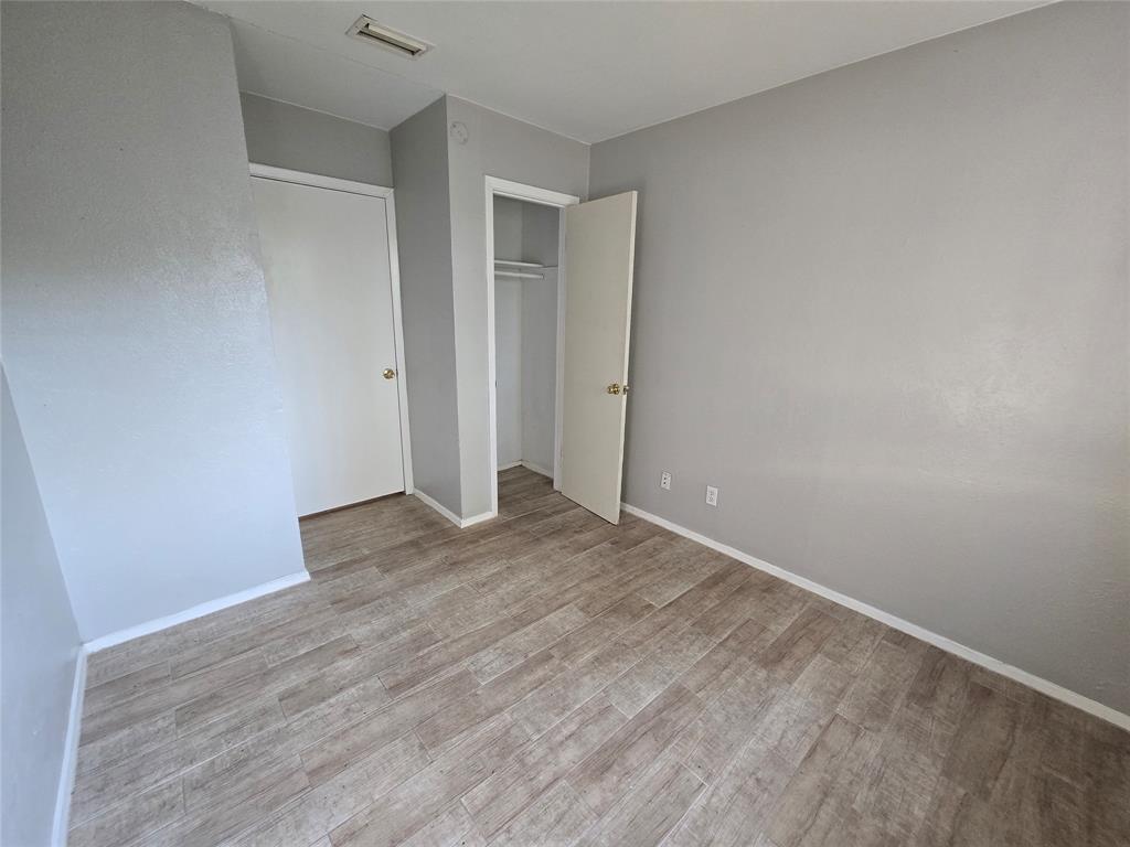 6108 Lazy River Drive Dallas, TX 75241 - Photo 11 of 16 a view of an empty room and wooden floor