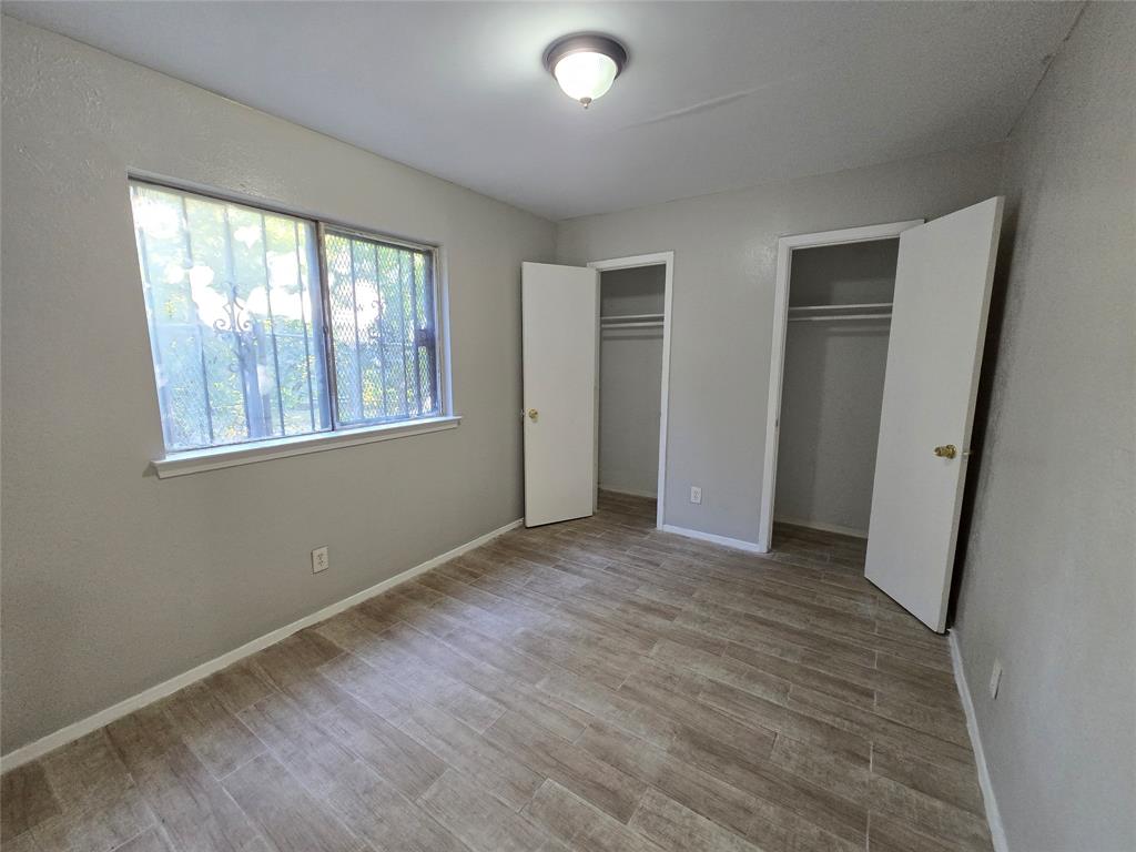 6108 Lazy River Drive Dallas, TX 75241 - Photo 13 of 16 a view of an empty room with wooden floor and a window