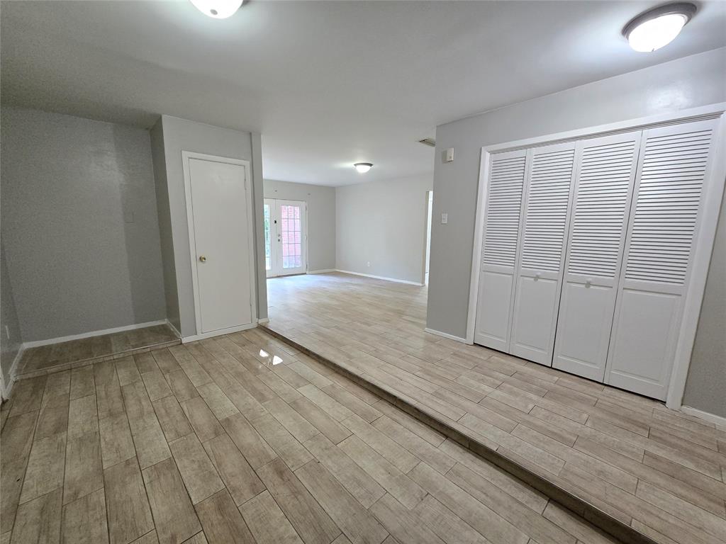 6108 Lazy River Drive Dallas, TX 75241 - Photo 3 of 16 a view of an empty room and wooden floor