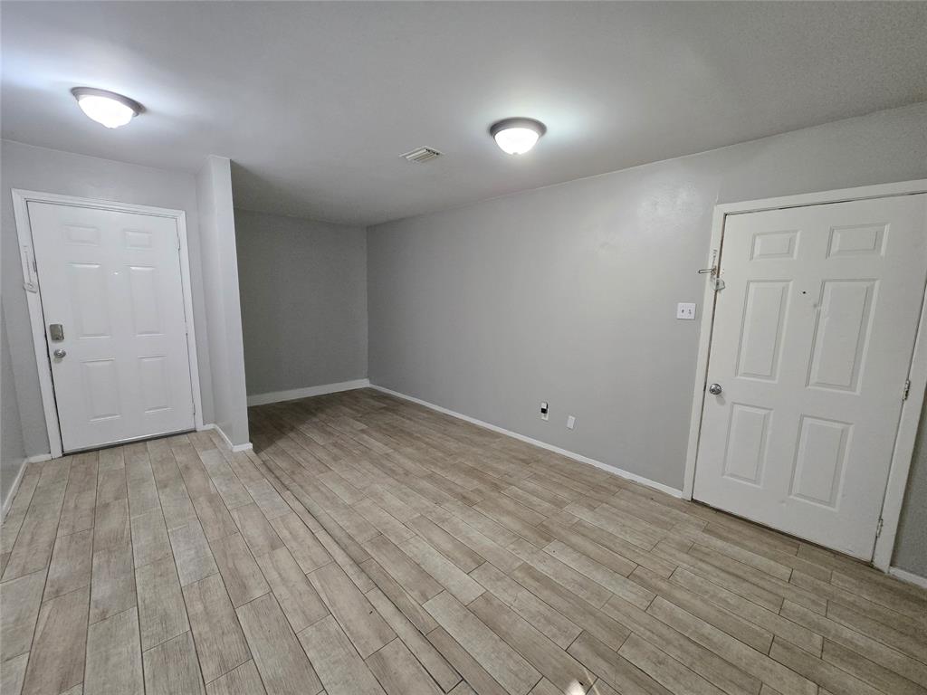 6108 Lazy River Drive Dallas, TX 75241 - Photo 6 of 16 a view of an empty room with wooden floor