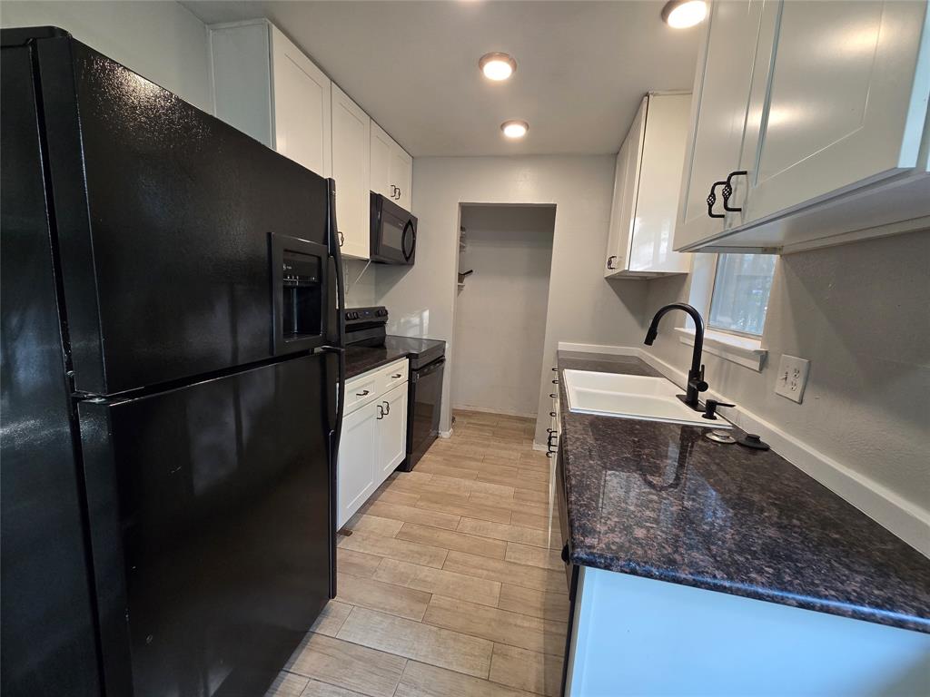 6108 Lazy River Drive Dallas, TX 75241 - Photo 7 of 16 a kitchen with a refrigerator and a sink