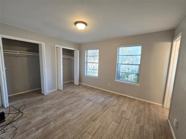 an empty room with windows and closet