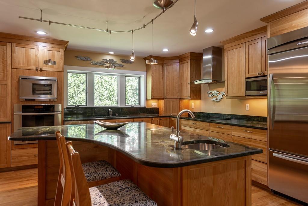 100 Ortins Road Hamilton, MA 01982 - Photo 5 of 41 a kitchen with kitchen island a sink appliances and a counter top space