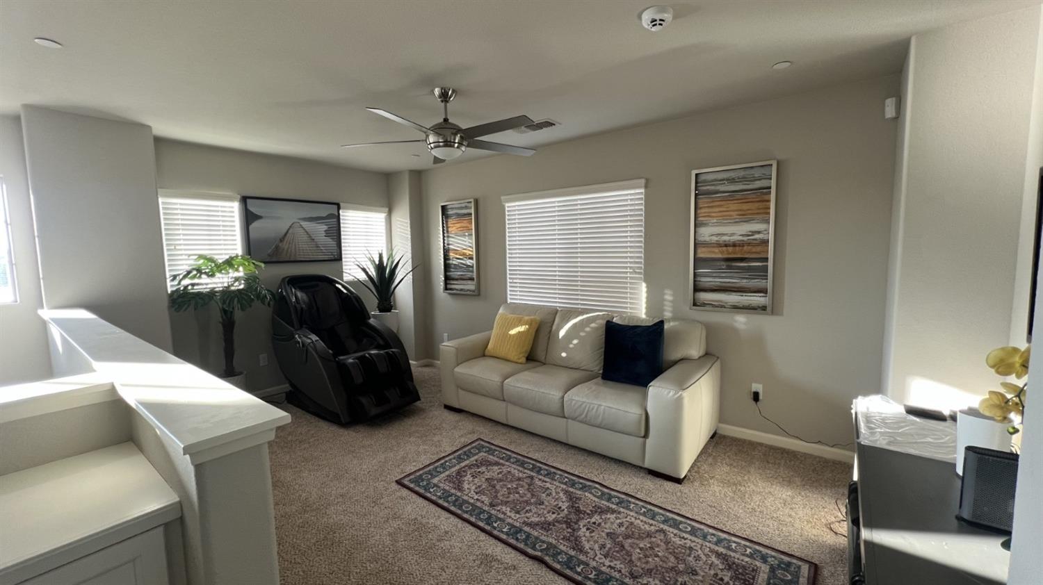 3525 Cordova Avenue Clovis, CA 93619 - Photo 21 of 35 a living room with furniture a ceiling fan and a window