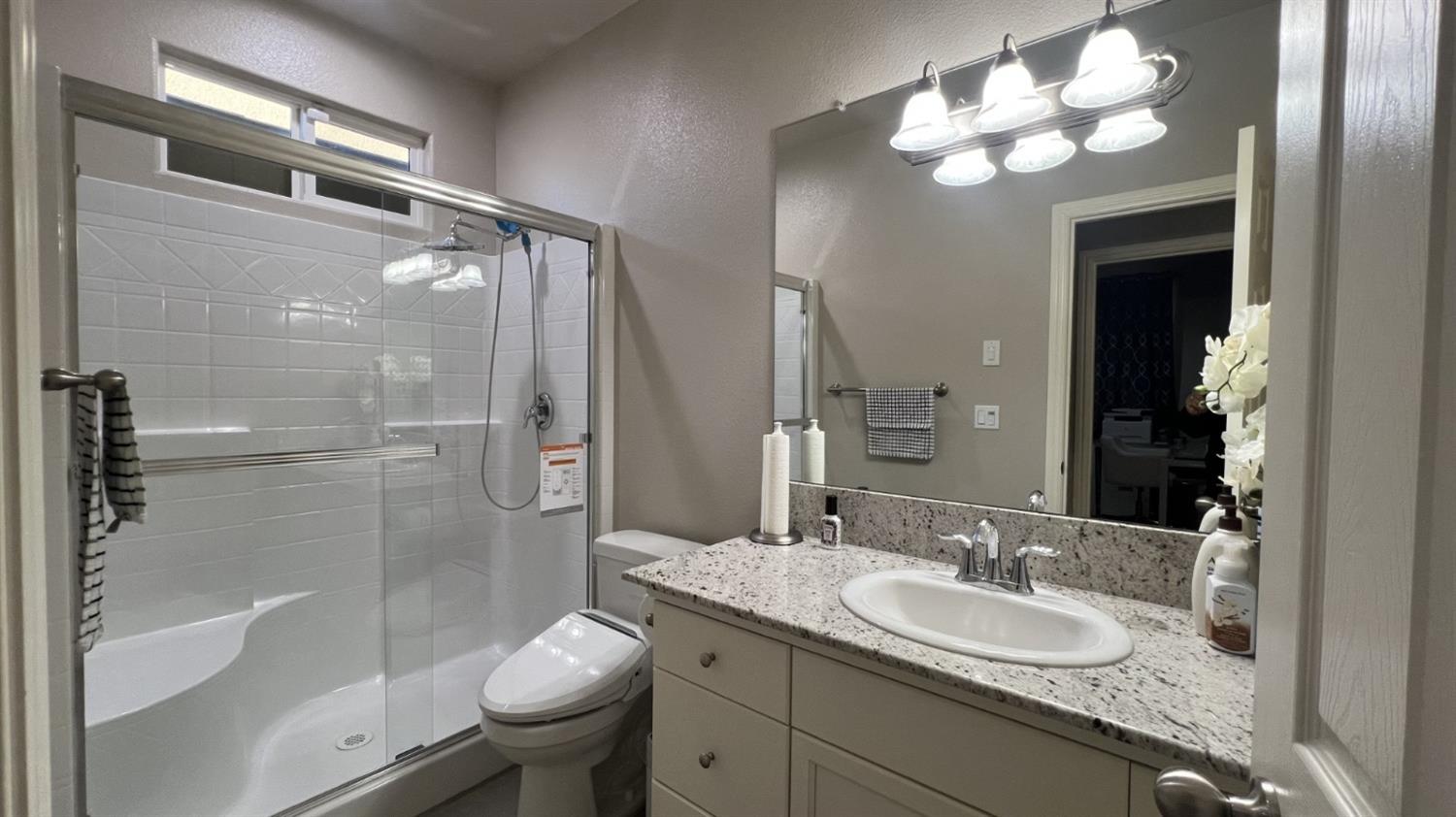 3525 Cordova Avenue Clovis, CA 93619 - Photo 24 of 35 a bathroom with a granite countertop sink toilet and shower