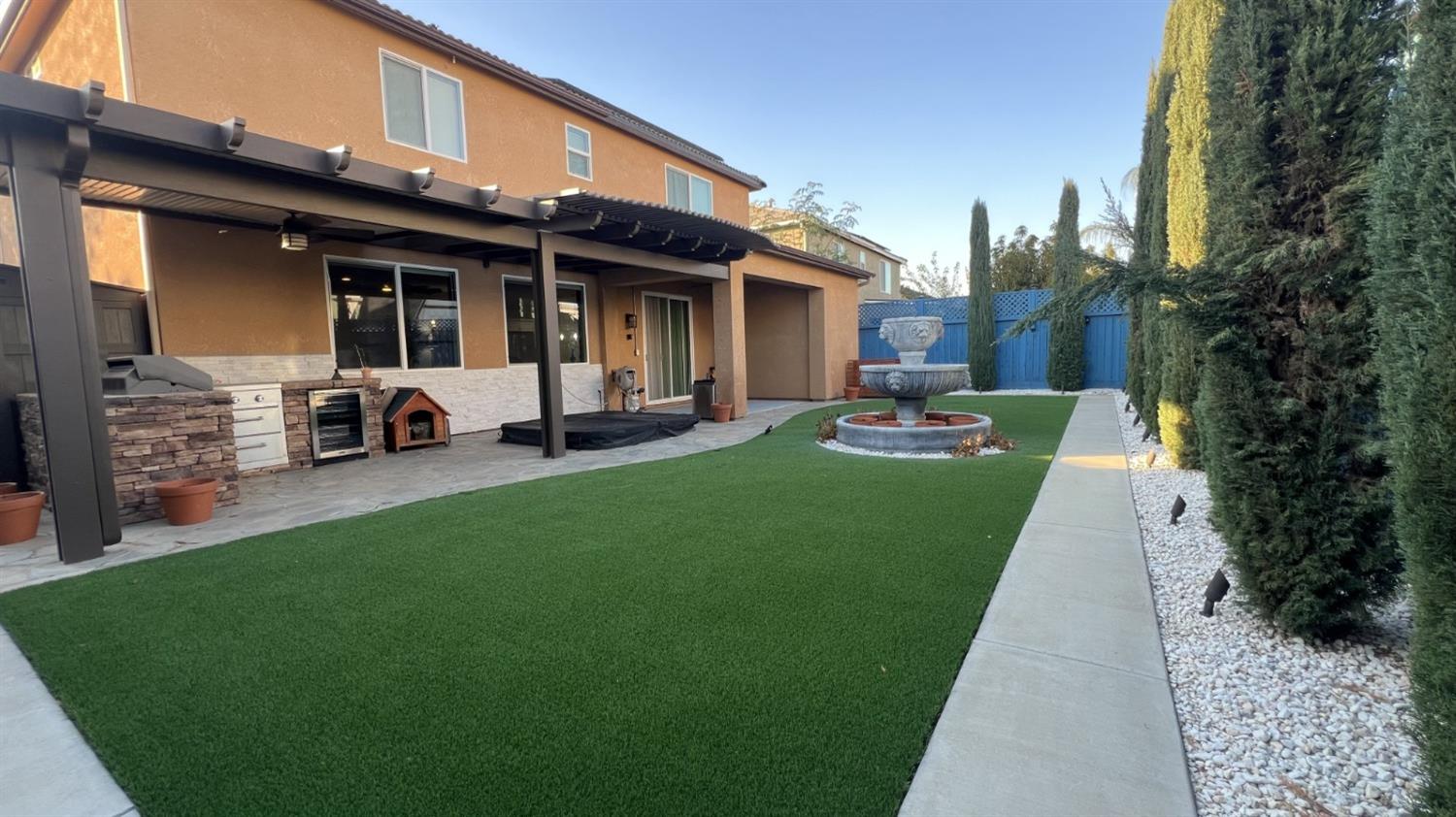 3525 Cordova Avenue Clovis, CA 93619 - Photo 30 of 35 a front view of a house with a garden and patio