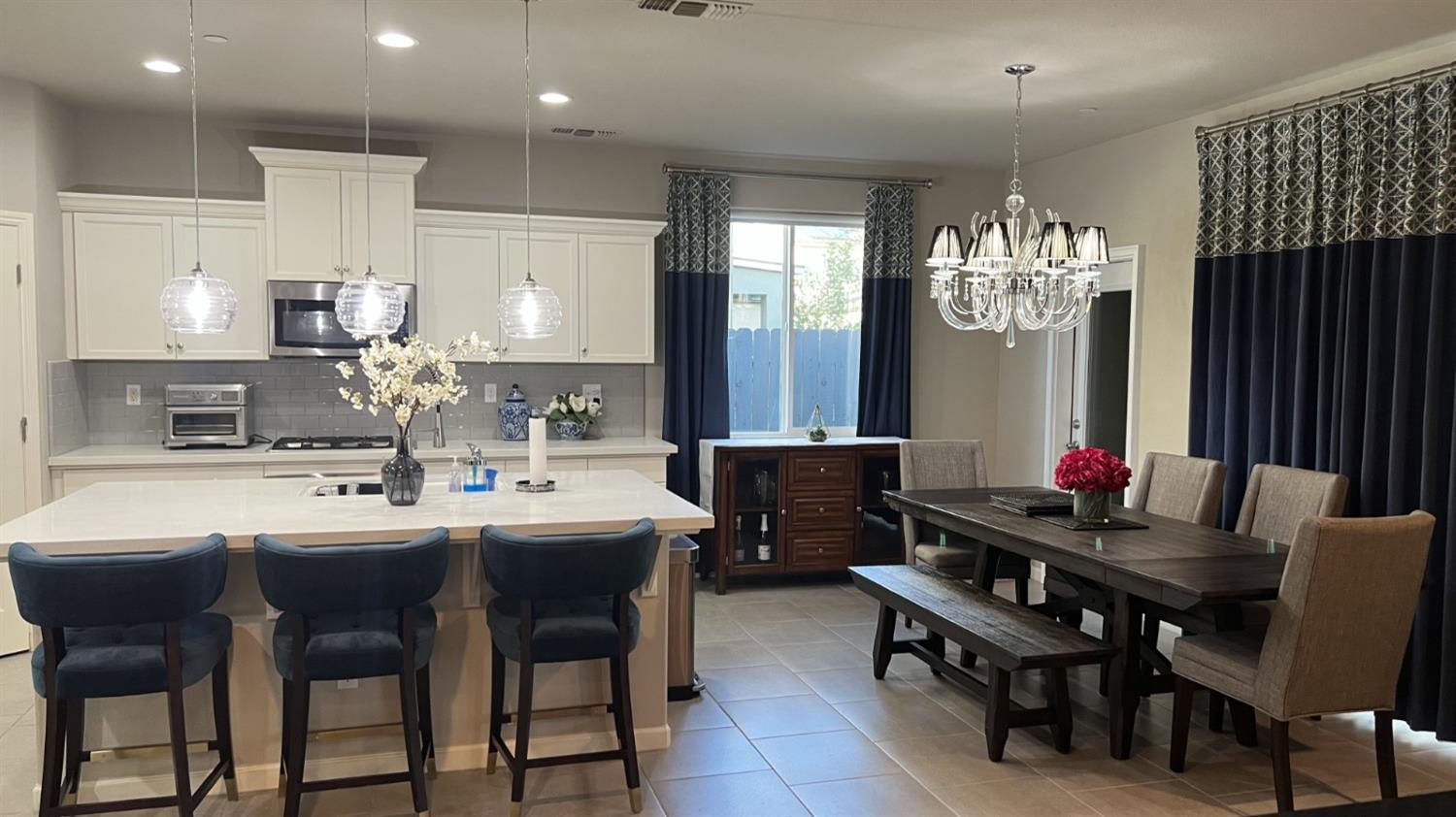 3525 Cordova Avenue Clovis, CA 93619 - Photo 7 of 35 a kitchen with stainless steel appliances a dining table and chairs