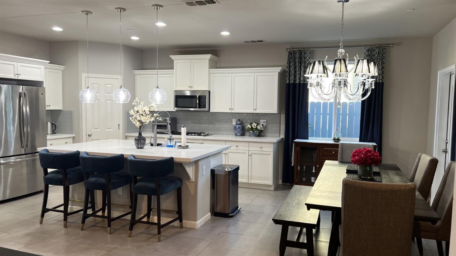 3525 Cordova Avenue Clovis, CA 93619 - Photo 9 of 35 a kitchen with kitchen island granite countertop a sink dining table and chairs