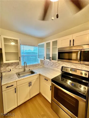 a kitchen with stainless steel appliances granite countertop a sink and cabinets