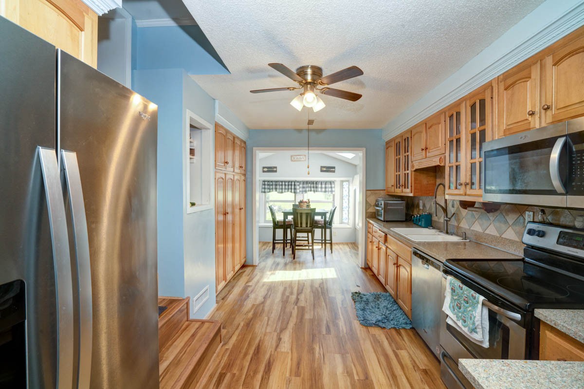 1157 Morgan Road Lafayette, TN 37083 - Photo 12 of 45 a kitchen with stainless steel appliances granite countertop a refrigerator a stove top oven a sink and dishwasher