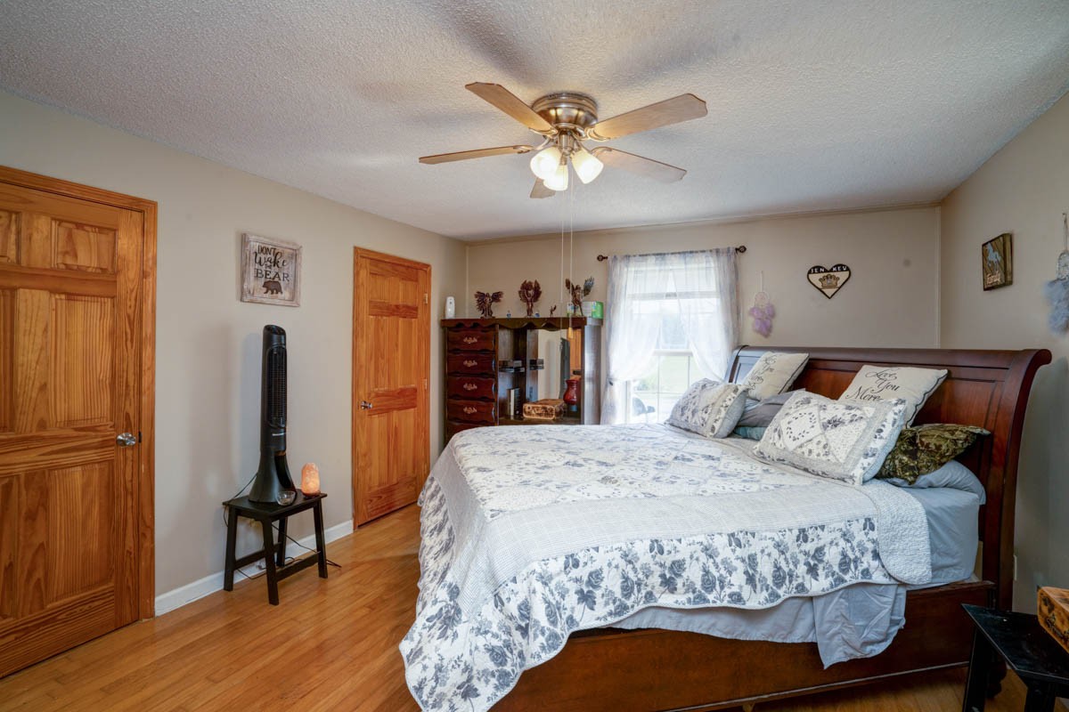 1157 Morgan Road Lafayette, TN 37083 - Photo 17 of 45 a bedroom with a bed and a chandelier