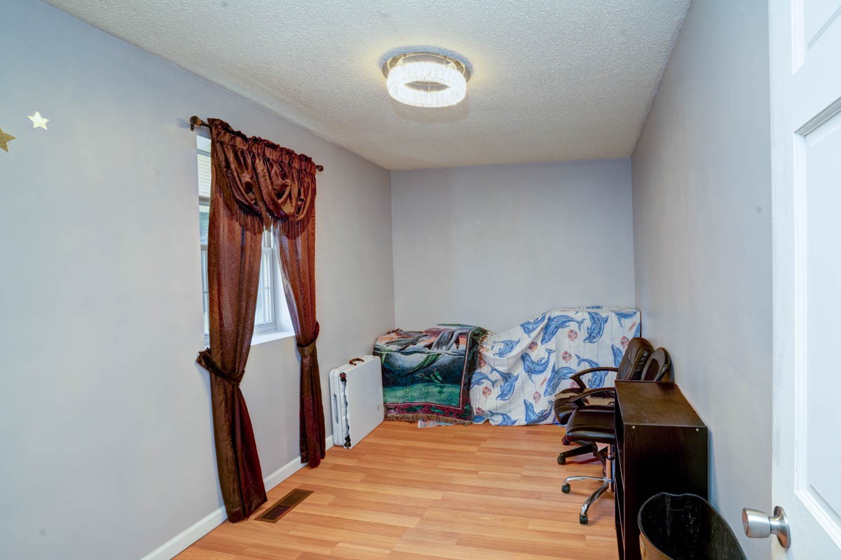 1157 Morgan Road Lafayette, TN 37083 - Photo 25 of 45 a bedroom with a bed and a chandelier