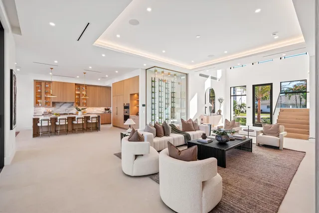 a living room with furniture and large windows