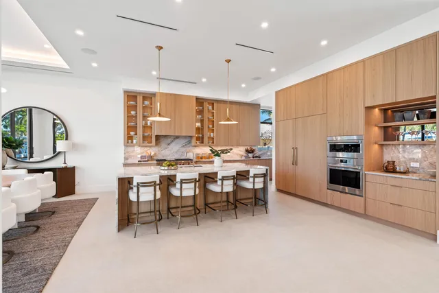 a large kitchen with a table and chairs in it