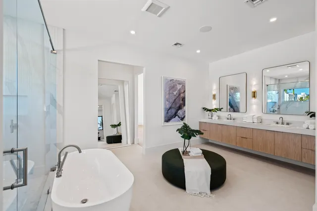 a large white kitchen with a large tub and sink