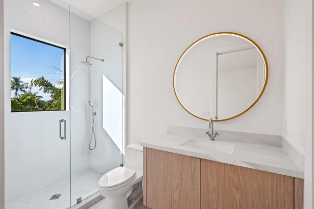 a bathroom with a toilet a sink and a mirror
