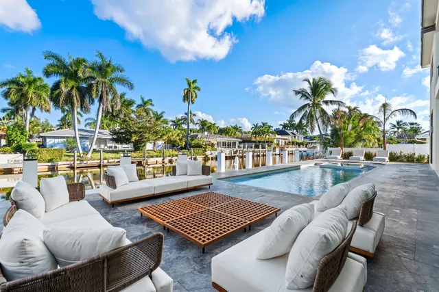 a outdoor living room with furniture and a potted plant