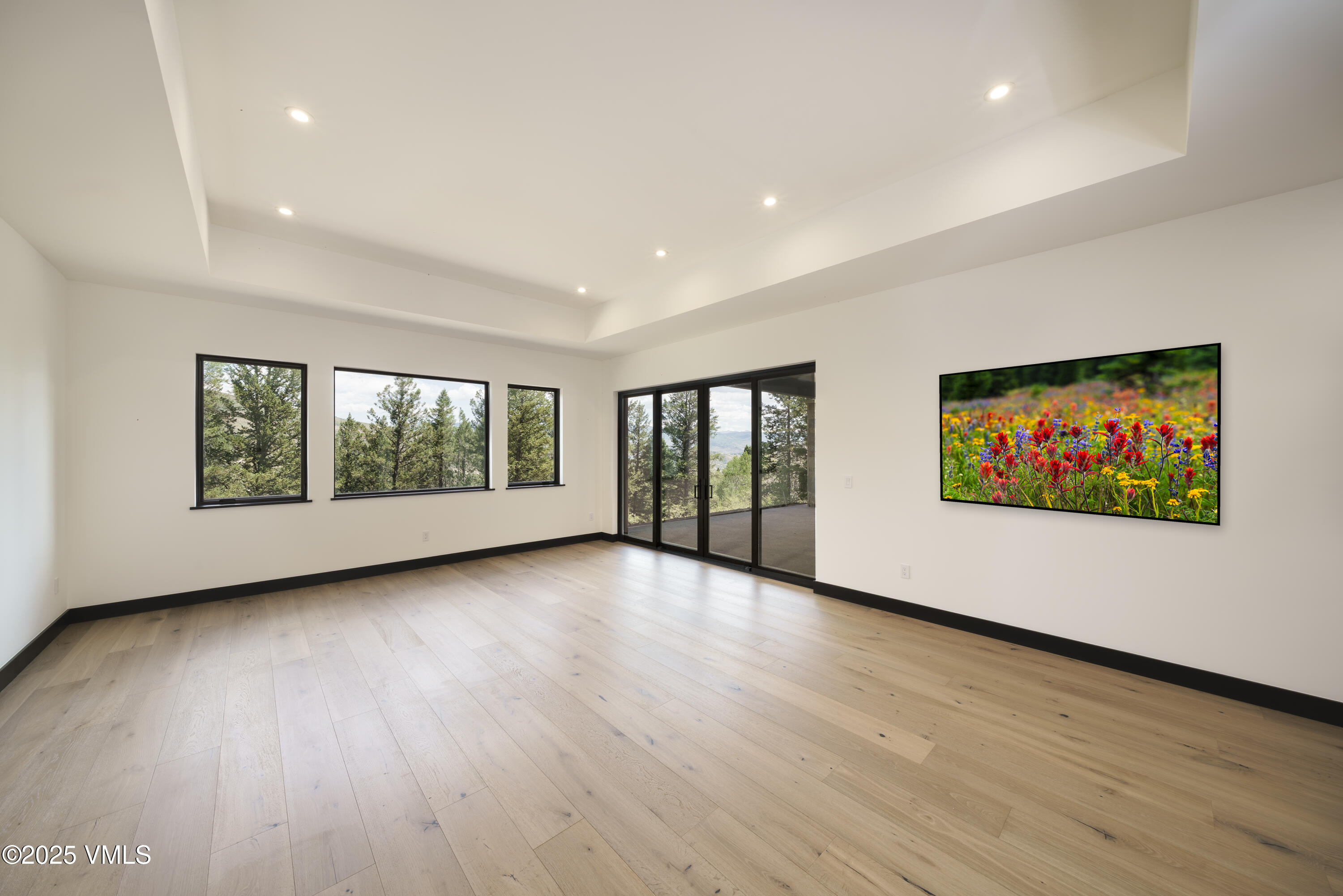 171 Sunquist Road Edwards, CO 81632 - Photo 61 of 101 a view of an empty room with wooden floor and windows