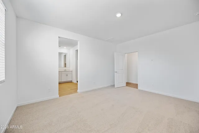 a spacious bathroom with a granite countertop sink mirror and a shower