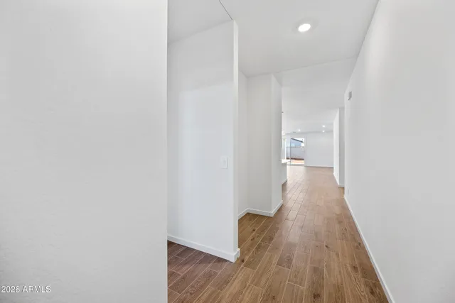 a view of a hallway with wooden floor