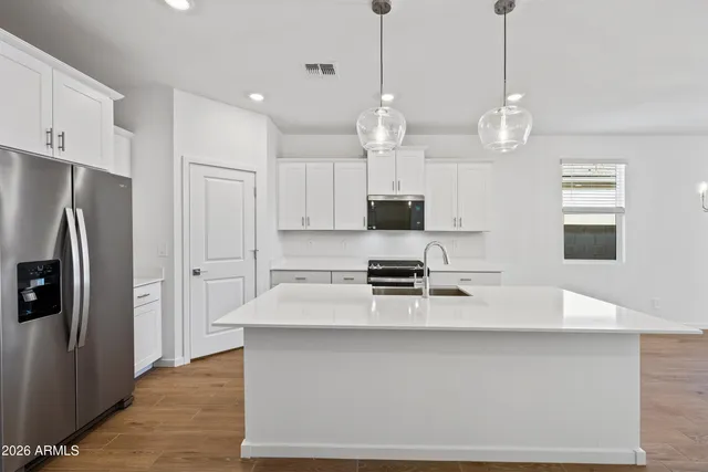 a kitchen with a sink stainless steel appliances and cabinets
