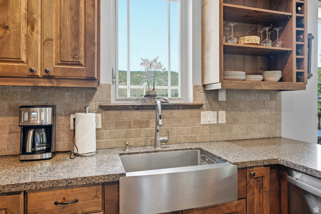 3148 Lower Saddleback Road Park City, UT 84098 - Photo 17 of 67 Kitchen featuring granite-look countertops, a stainless steel farmhouse sink with a gooseneck faucet, light brown subway tile backsplash, and wood-finish cabinetry