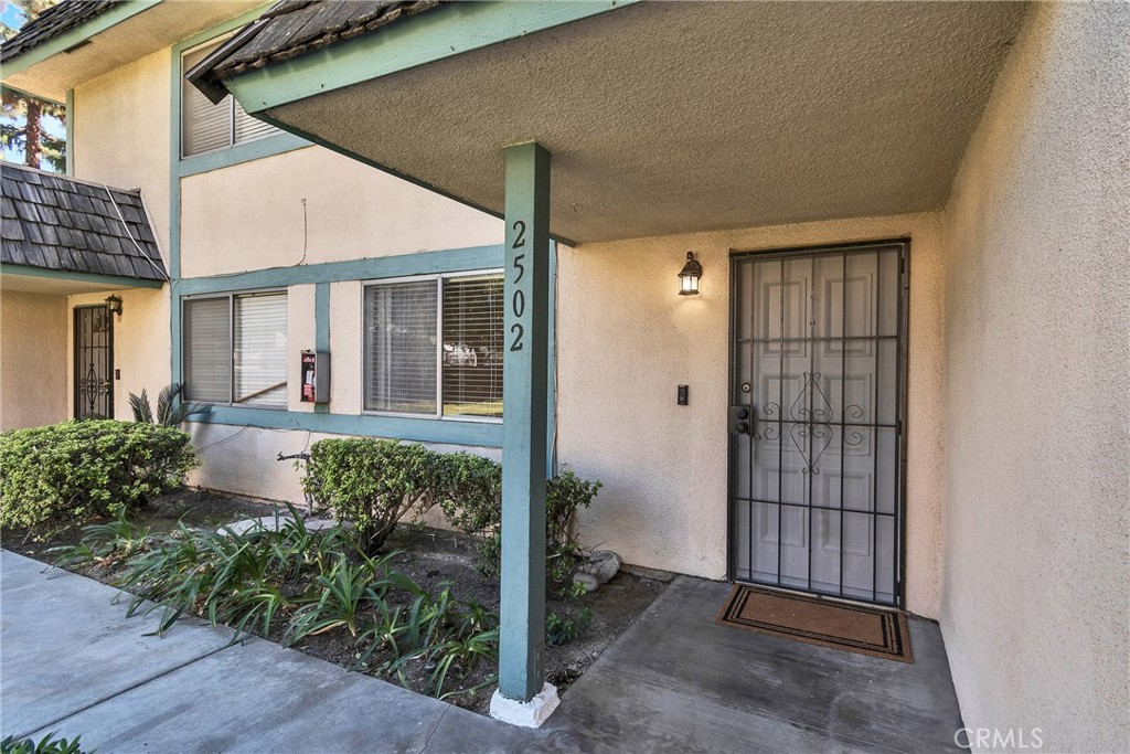2502 Bryn Mawr Lane Riverside, CA 92507 - Photo 1 of 1 front view of a house with a glass door and potted plants