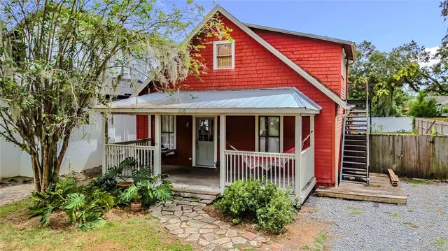 a view of a house with a small yard and plants