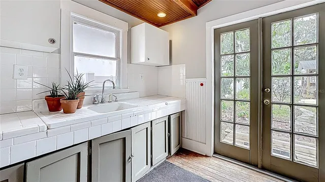 a kitchen with a sink and large window