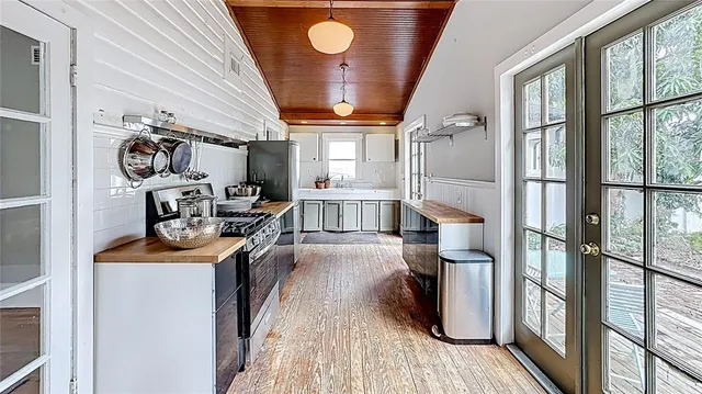 a kitchen with stainless steel appliances granite countertop a stove and a refrigerator