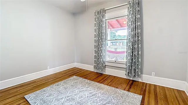 a view of a small space with wooden floor and windows