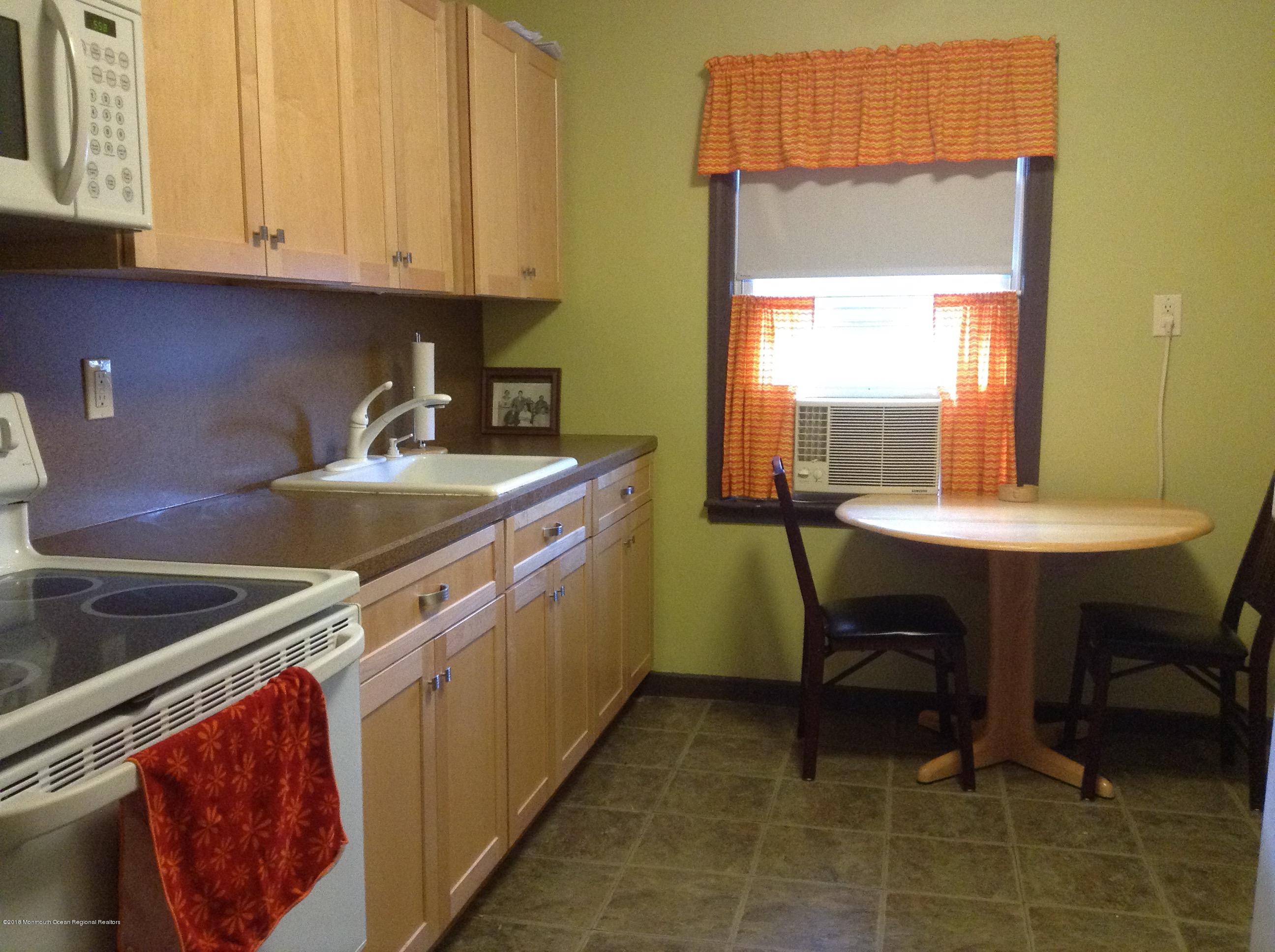 22 Pinckney Road, Unit C Red Bank, NJ 07701 - Photo 5 of 13 a kitchen with a sink cabinets and wooden floor