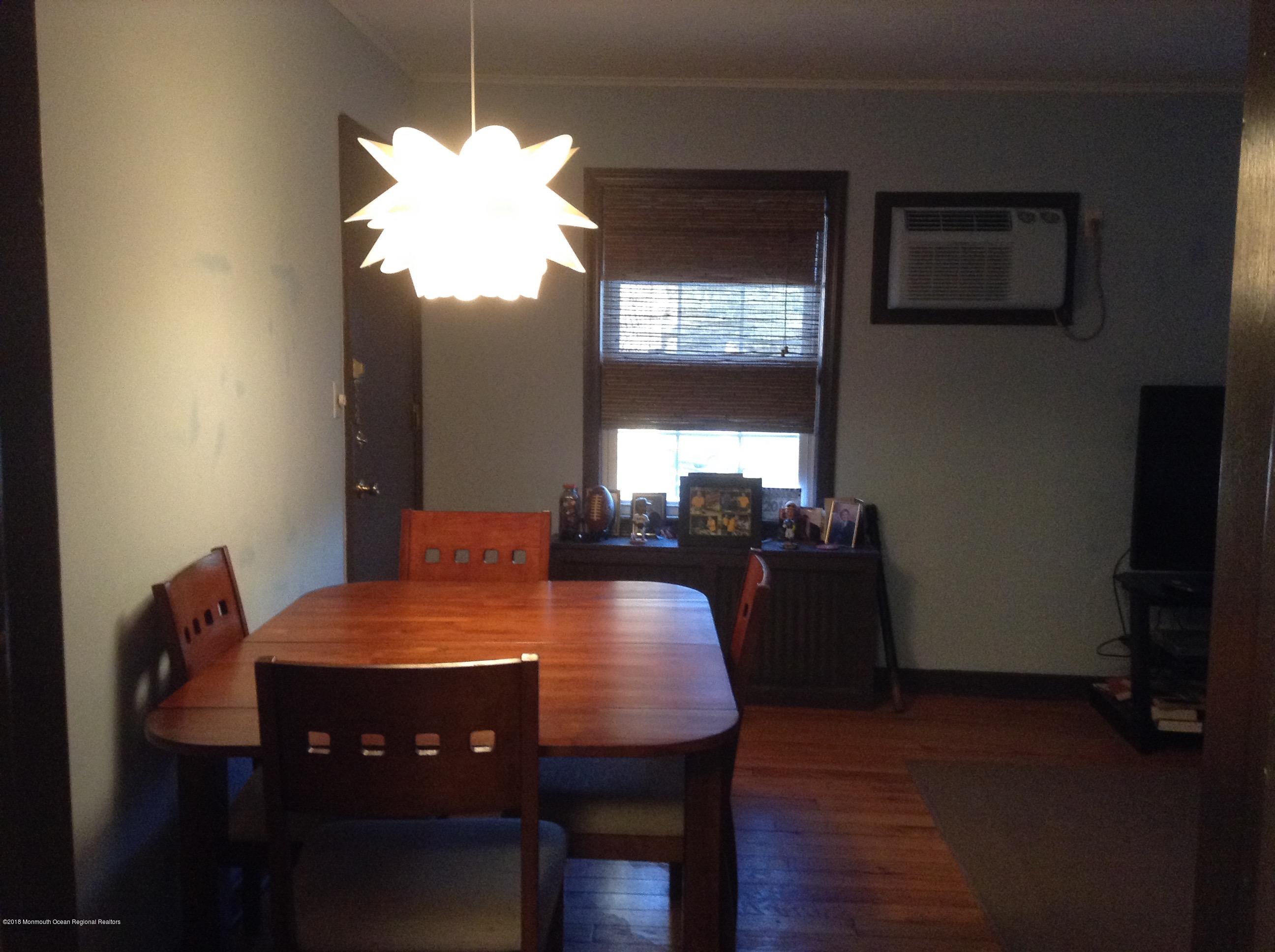 22 Pinckney Road, Unit C Red Bank, NJ 07701 - Photo 8 of 13 a view of a dining room with furniture and wooden floor