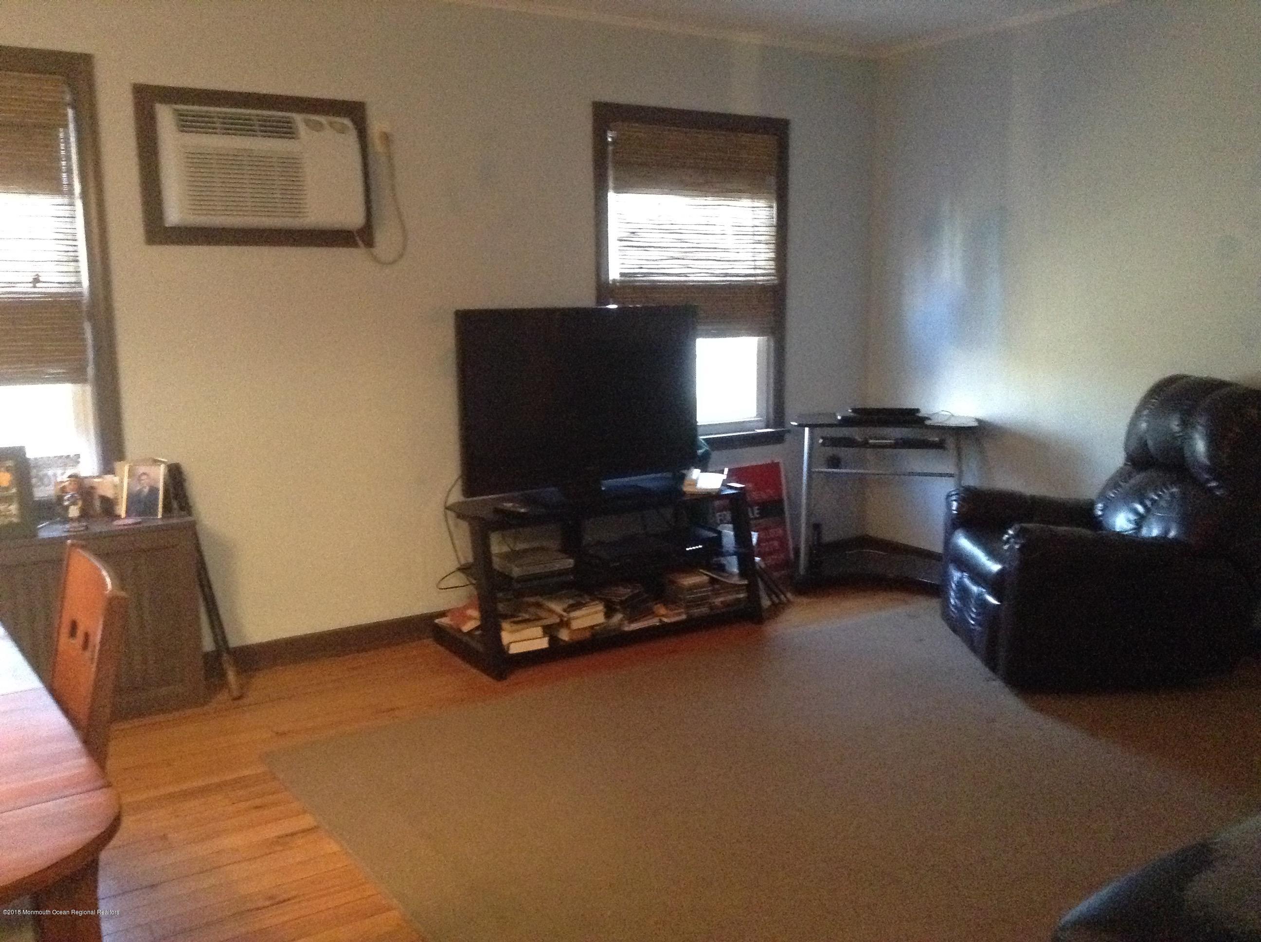 22 Pinckney Road, Unit C Red Bank, NJ 07701 - Photo 9 of 13 a living room with furniture window and a flat screen tv