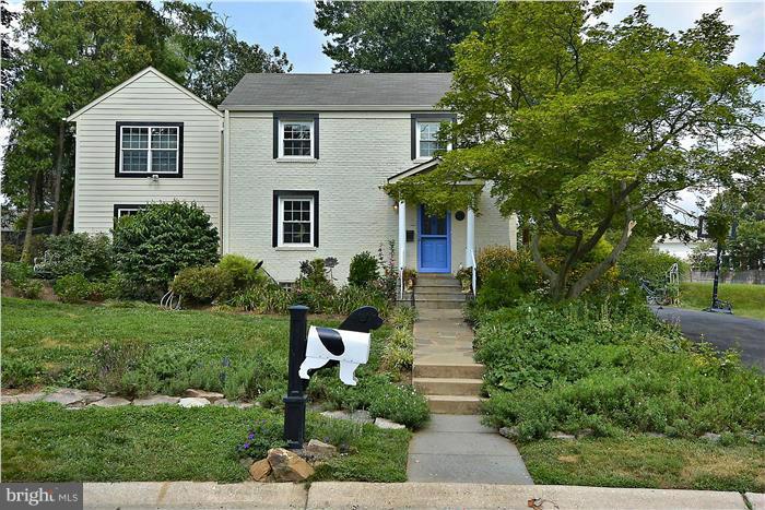 8731 Ridge Road Bethesda, MD 20817 - Photo 1 of 29 a front view of a house with a yard and trees